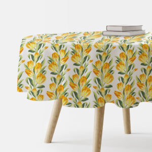 okrągły obrus z żółtymi tulipanami na białym tle na stole, widok z boku z książkami na krawędzi