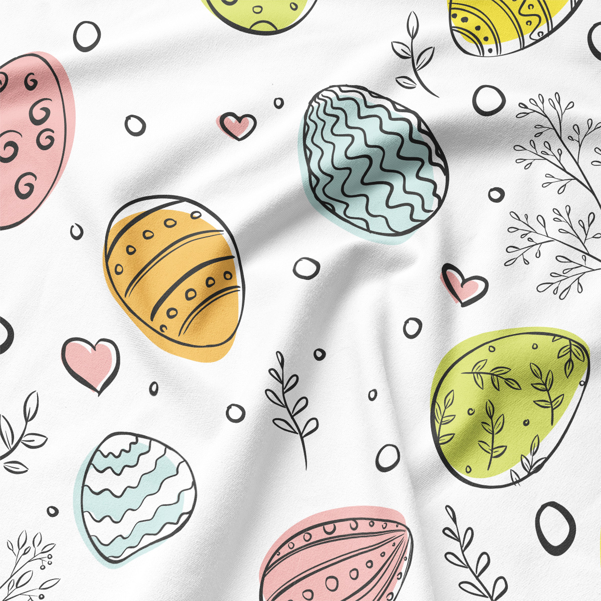 Zbliżenie na tkaninę z rysunkowymi pisankami w pastelowych odcieniach i cienkimi, ozdobnymi gałązkami