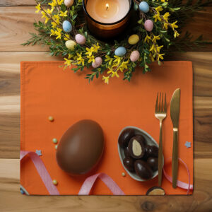Aranżacja stołu z podkładką, złotymi sztućcami i wiosennym wieńcem z mini pisankami