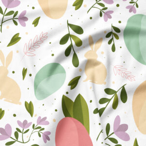 Zbliżenie na detal wzoru: sylwetka zajączka, pastelowa pisanka i liście na tkaninie