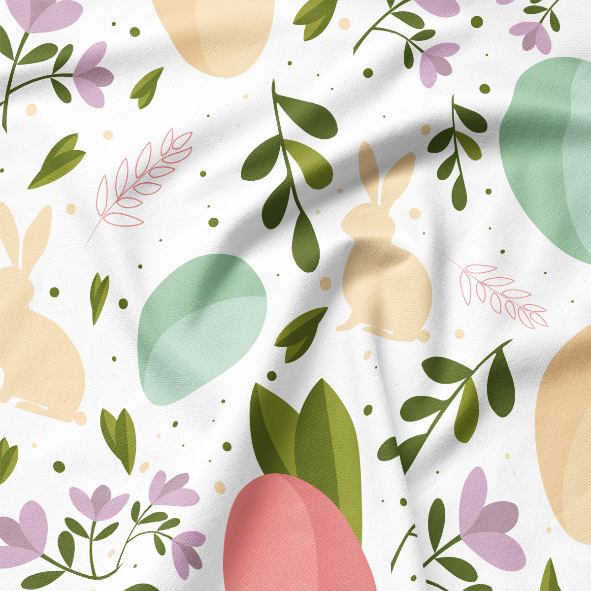 Zbliżenie na detal wzoru: sylwetka zajączka, pastelowa pisanka i liście na tkaninie