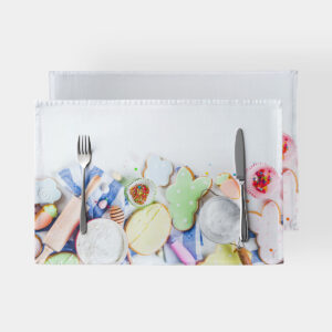 Podkładki z motywem pisank i lukrowanych ciasteczek ułożone jedna na drugiej, widok z góry