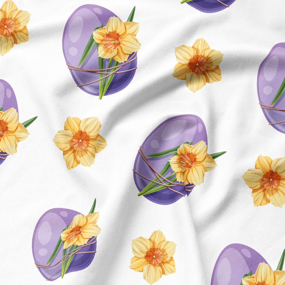 Zbliżenie na tkaninę ukazujące fioletową pisankę z wiązaniem i detal żonkila na białym tle