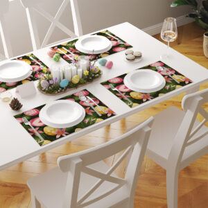 Aranżacja stołu z kilkoma podkładkami w motywy wielkanocne tworząca spójną dekorację nakrycia