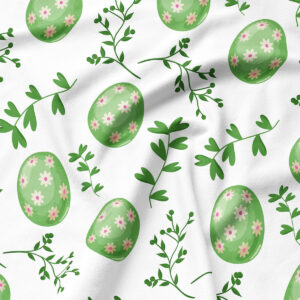 Zbliżenie na tkaninę z wzorem zielonych pisanek i delikatnych gałązek, widoczna struktura materiału