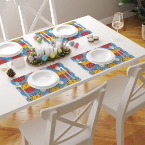 Komplet podkładek rozłożony na stole jako część świątecznej aranżacji z talerzami i dekoracjami