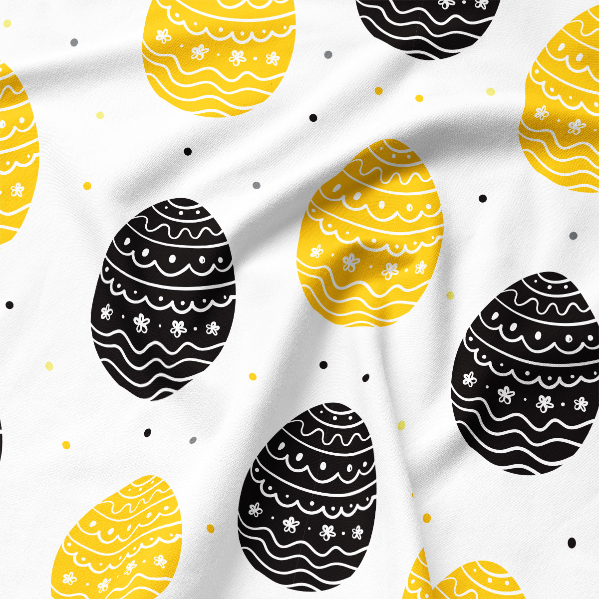 zbliżenie na tkaninę z motywem pisanek pokazujące fakturę i detale wzoru w żółci i czerni