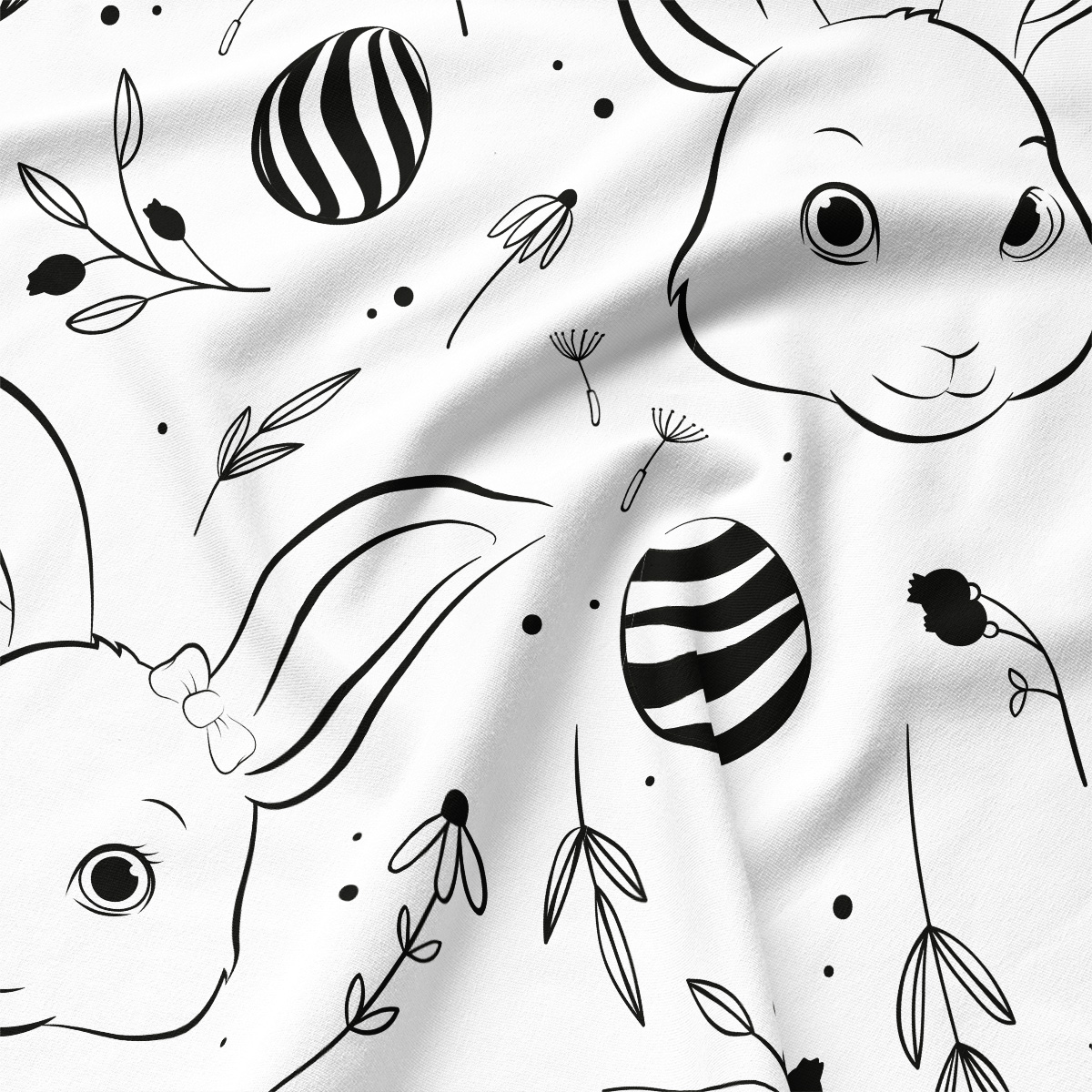 Zbliżenie na czarno-biały nadruk z króliczką, pisanką i delikatnymi listkami, widoczna faktura tkaniny