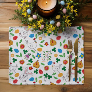 Aranżacja stołu z podkładką, świecą i wielkanocnym wieńcem