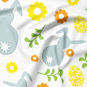 Zbliżenie na wzór i fakturę tkaniny z sylwetkami zajączków, drobnymi kwiatami i ozdobnymi pisankami