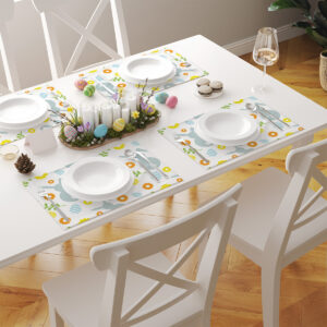 Widok stołu z kilkoma podkładkami o tym samym motywie tworzącymi spójną wielkanocną dekorację