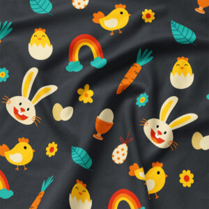 Zbliżenie na fakturę tkaniny z kolorowymi motywami króliczków, kurczątek, jajek i marchewek