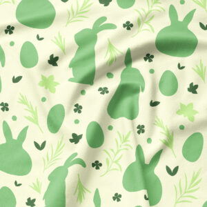 Zbliżenie na tkaninę z motywem zielonych zajączków, pisanek i drobnych listków