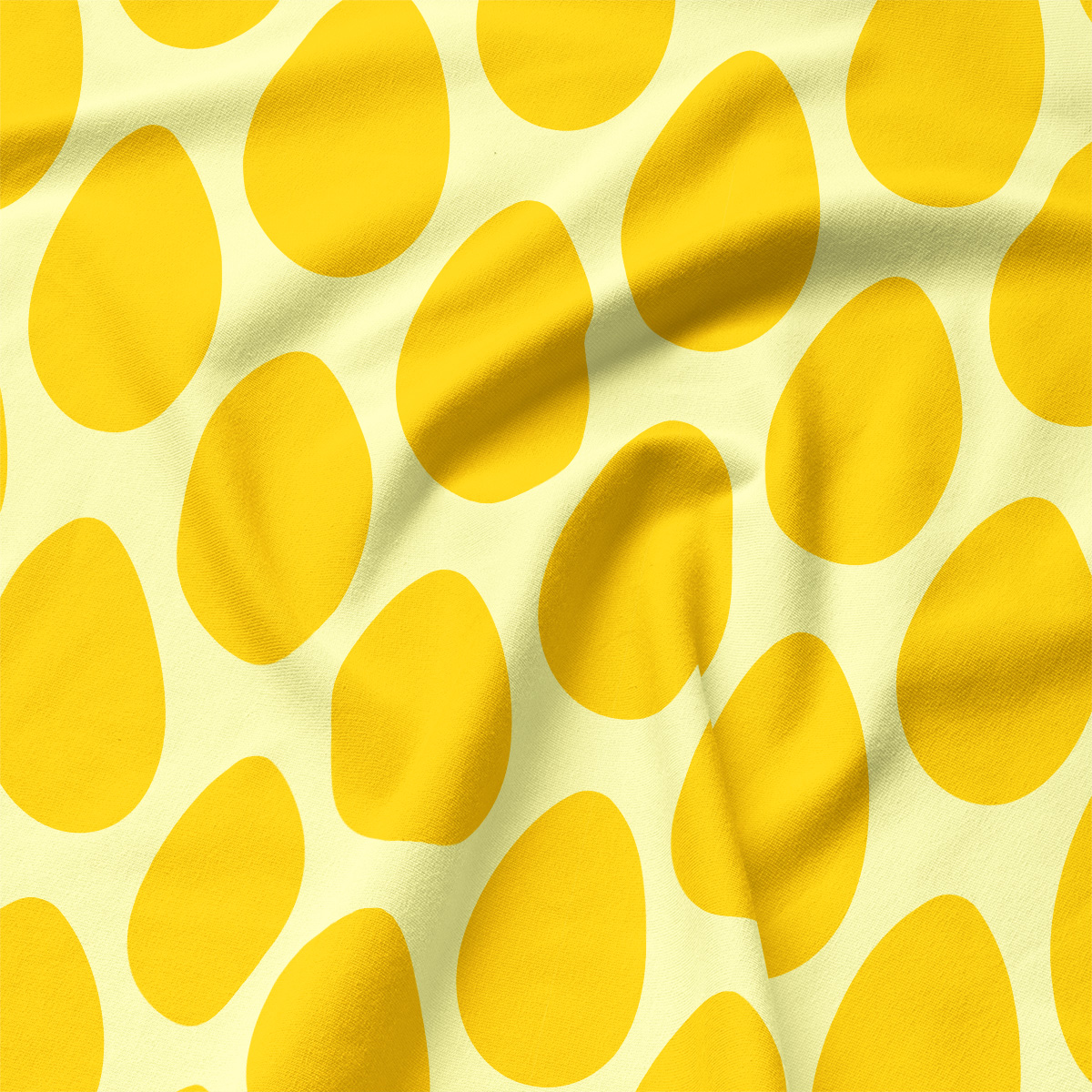 Zbliżenie na tkaninę podkładki z powtarzającymi się żółtymi jajkowatymi kształtami