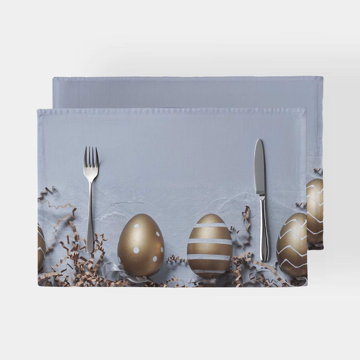 Główne ujęcie podkładki z nadrukiem złotych pisanek na szarym tle