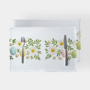 biała podkładka z motywem stokrotek i pastelowych pisanek na stole