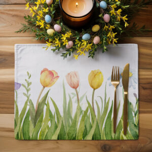 Stół udekorowany podkładką z wiosennym wieńcem i pisankami, aranżacja świąteczna
