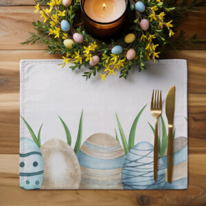 Aranżacja stołu z podkładką, świecami i wiosennymi dekoracjami w pastelowych kolorach