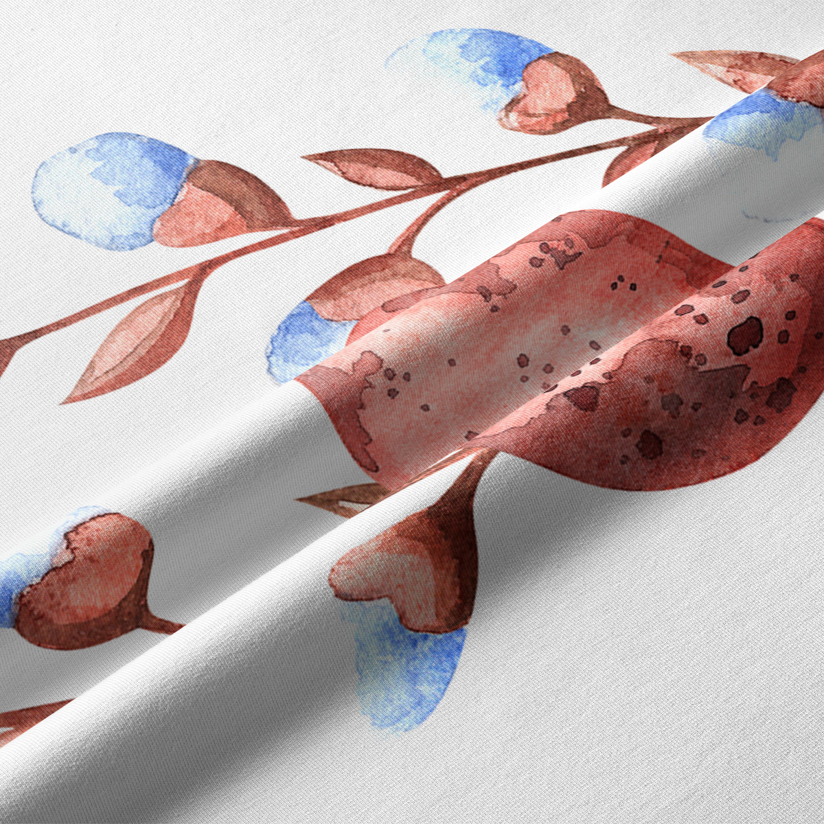 Zbliżenie na akwarelowy wzór pisanek i sercowatych listków na tkaninie