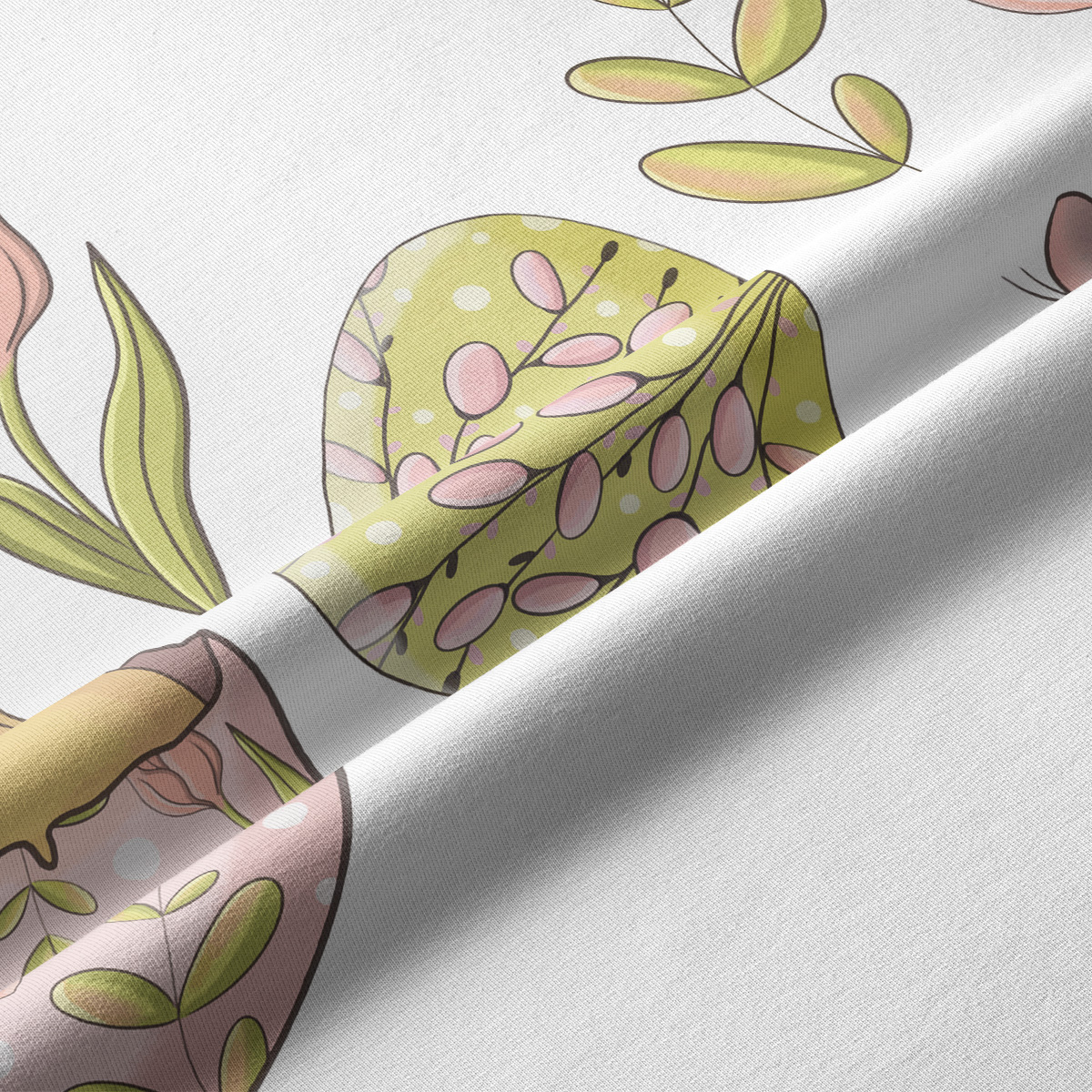 zbliżenie na tkaninę pokazujące pastelowe jajko z liśćmi i delikatną fakturę materiału