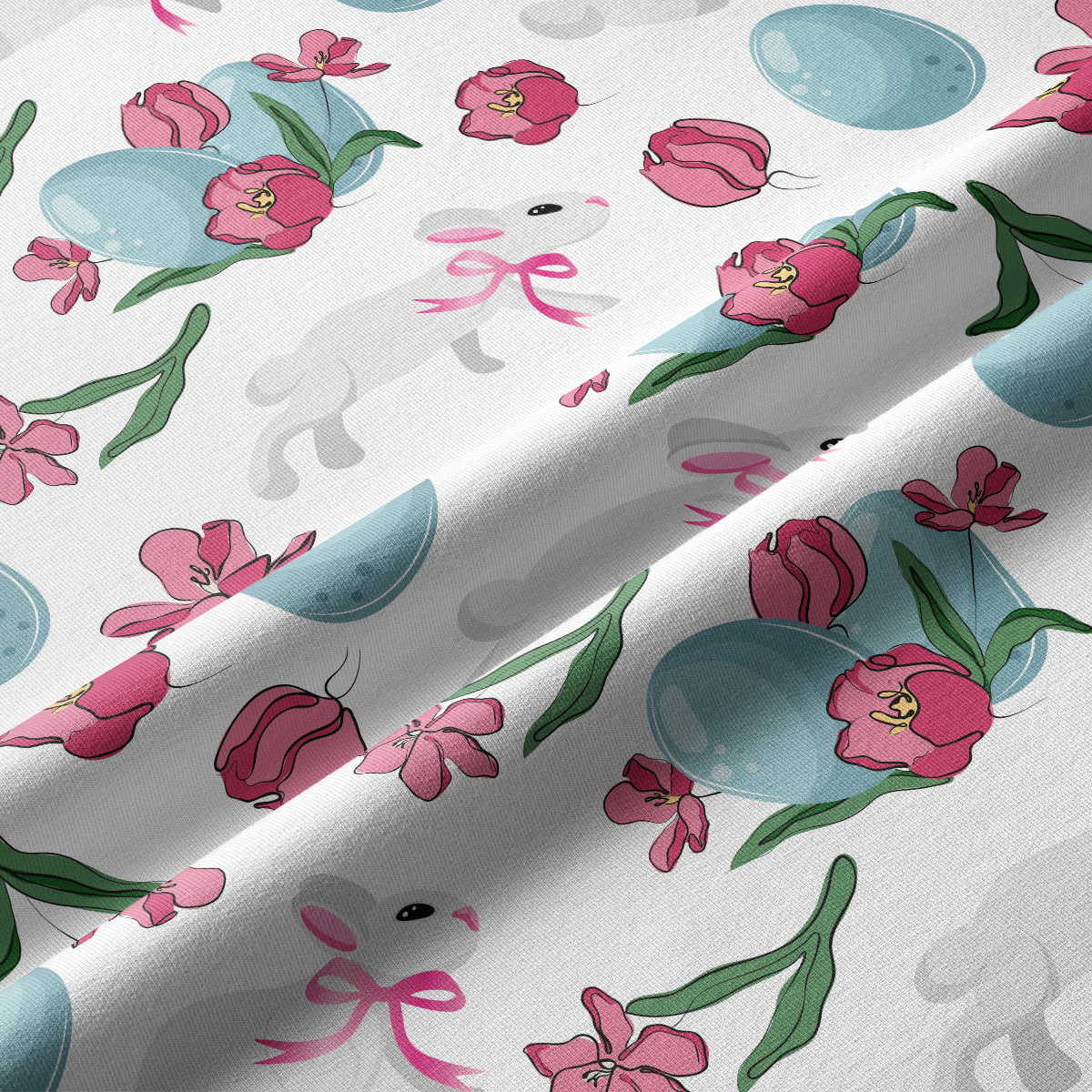 Zbliżenie na tkaninę pokazujące detale wzoru: zajączek z różową kokardką i niebieska pisanka