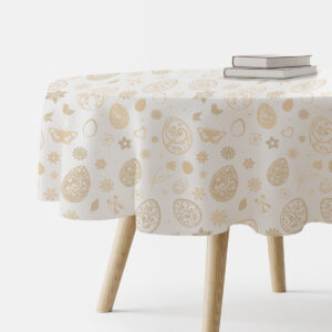 okrągły obrus na stole z kremowym wzorem pisanek i kwiatów
