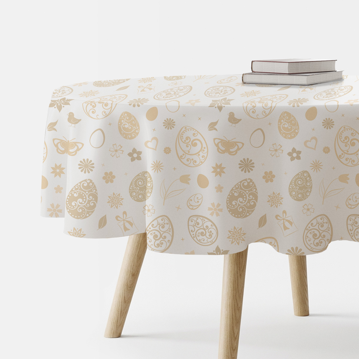 okrągły obrus na stole z kremowym wzorem pisanek i kwiatów