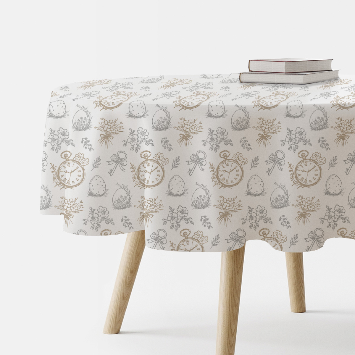 okrągły stół nakryty obrusem z motywem zegarków, pisanek i bukiecików