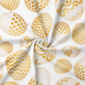 Zbliżenie na tkaninę z motywem pisanek, złote kropki i faliste linie