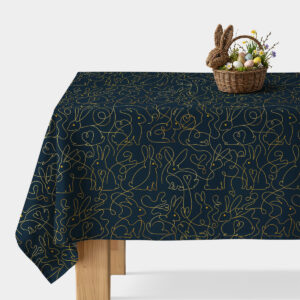 Obrus na stole z granatowym tłem i złotym wzorem króliczków, widok ogólny