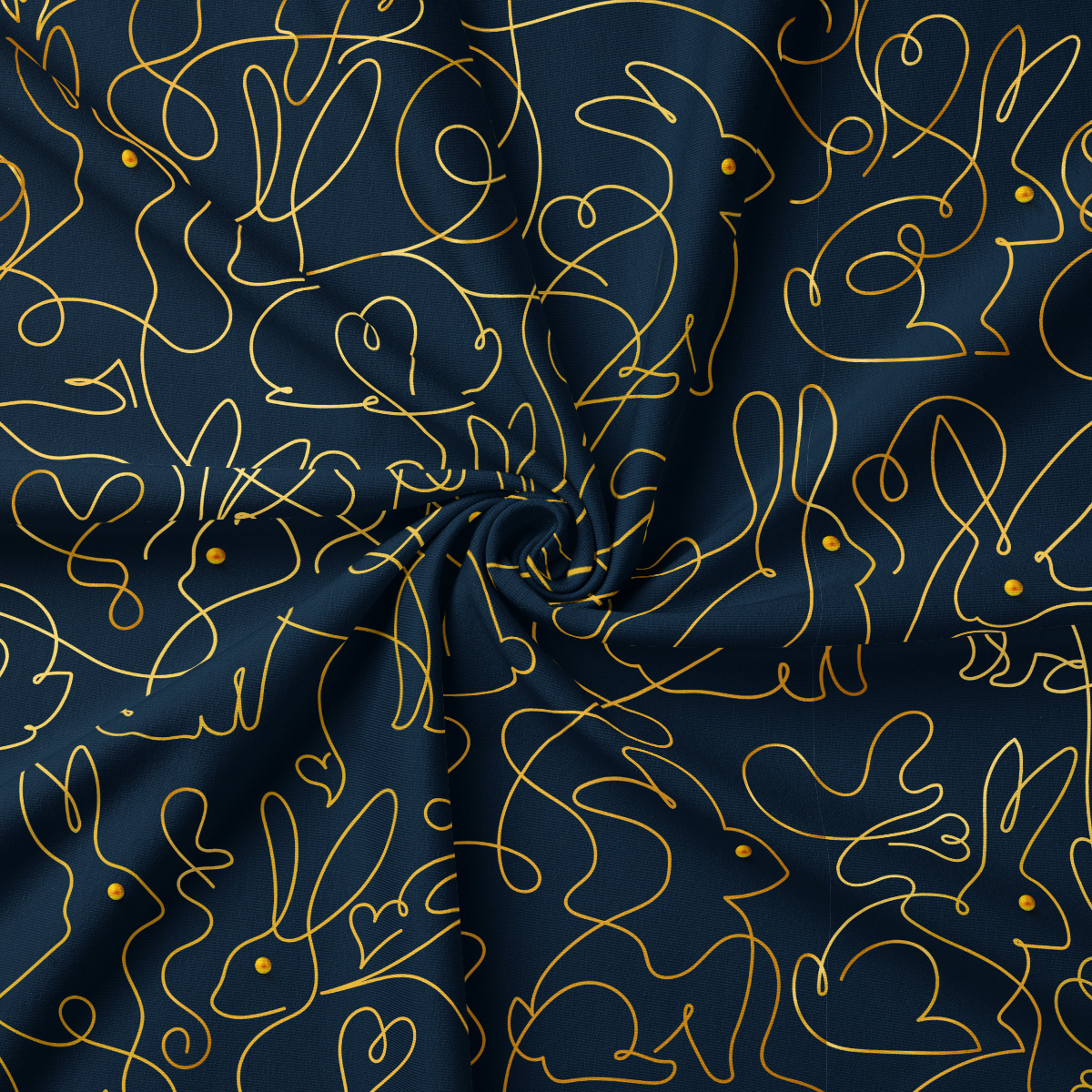 Zbliżenie na tkaninę i detale złotej, ciągłej kreski tworzącej sylwetki zajączków