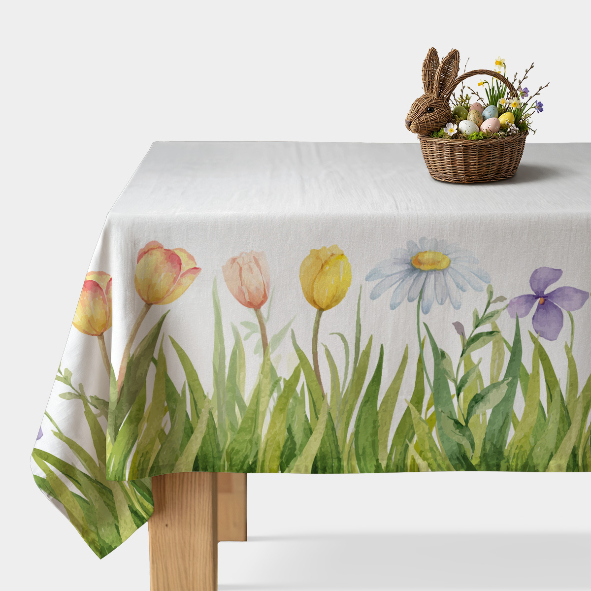 Obrus z akwarelowym motywem trawy, tulipanów i stokrotek na stole