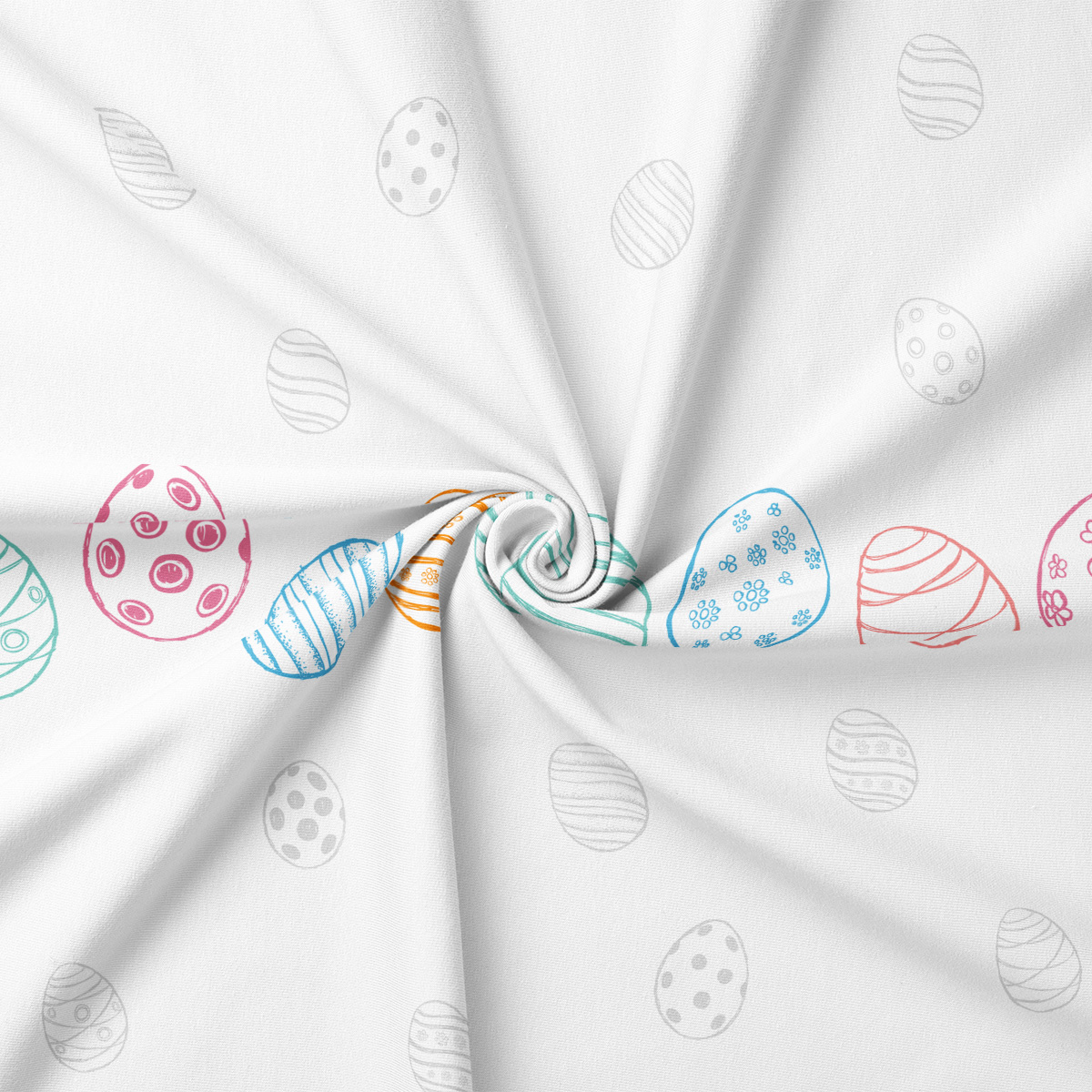 zbliżenie na tkaninę z pastelowymi pisankami i detalem nadruku przy skręceniu materiału