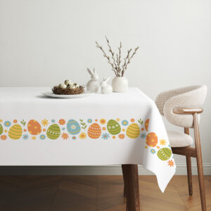 aranżacja stołu z obrusem, dekoracyjnym gniazdem jajek i gałązkami bazi