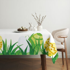 aranżacja stołu z obrusem, talerz z gniazdem i wiosenne dekoracje na jasnym tle