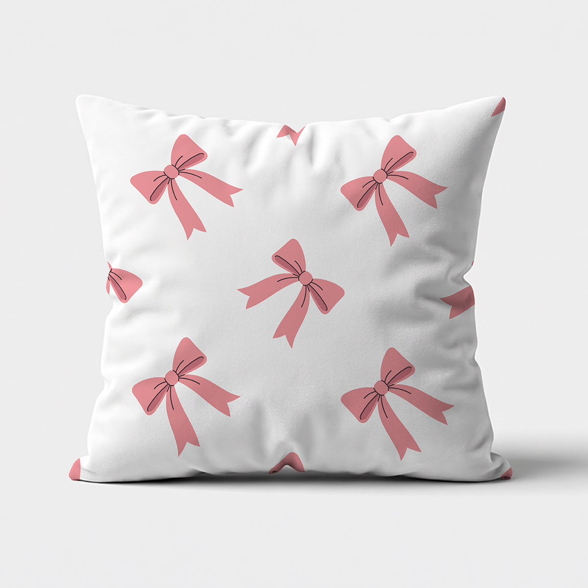 Poduszka dekoracyjna z różowymi kokardkami na jasnym tle — ujęcie z przodu