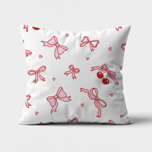Biała poduszka ozdobna z czerwonymi konturami kokardek i parą wiśni