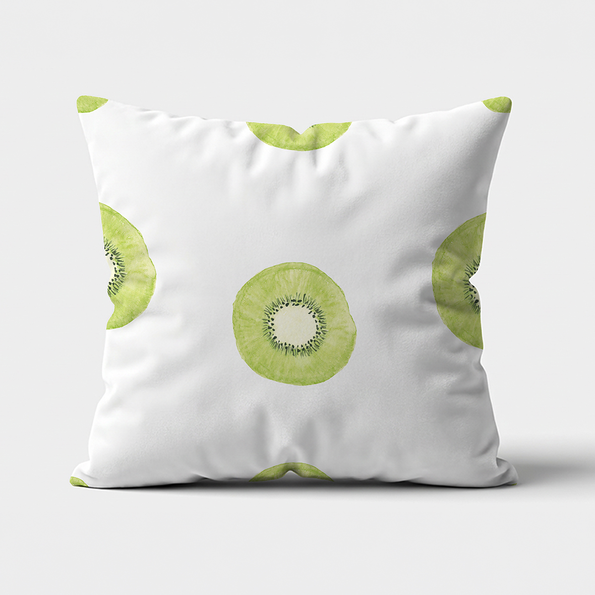 Frontowy widok poduszki z nadrukiem akwarelowych plasterków kiwi na jasnym tle