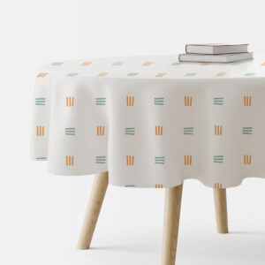 okrągły obrus na stole z widocznym wzorem delikatnych kresek w pomarańczowym i miętowym kolorze
