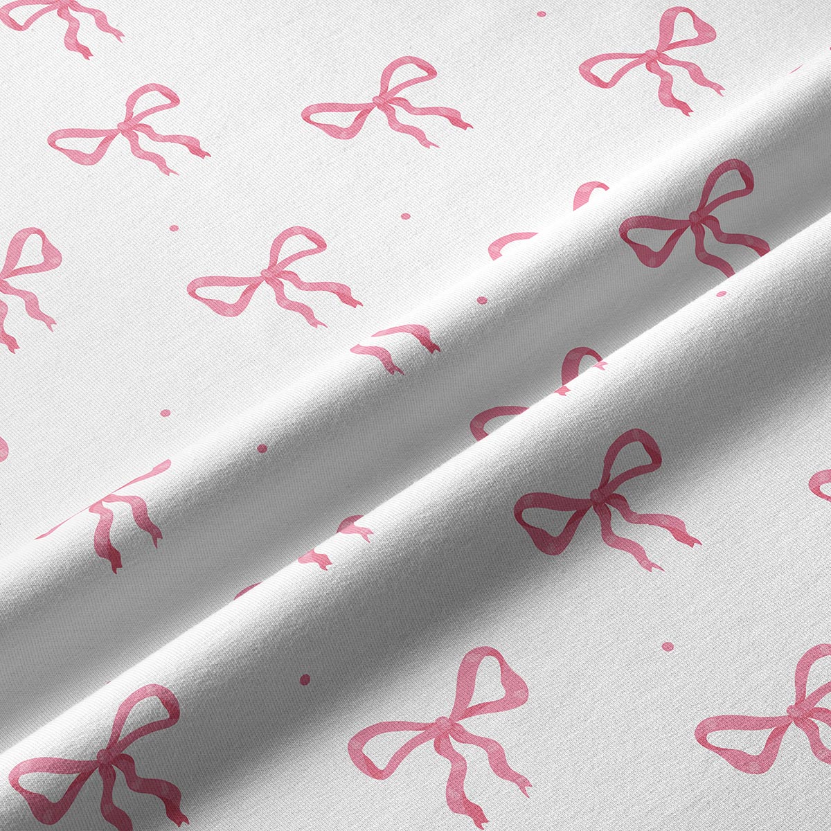 Zbliżenie na tkaninę i drobne różowe kokardki pokazujące fakturę materiału