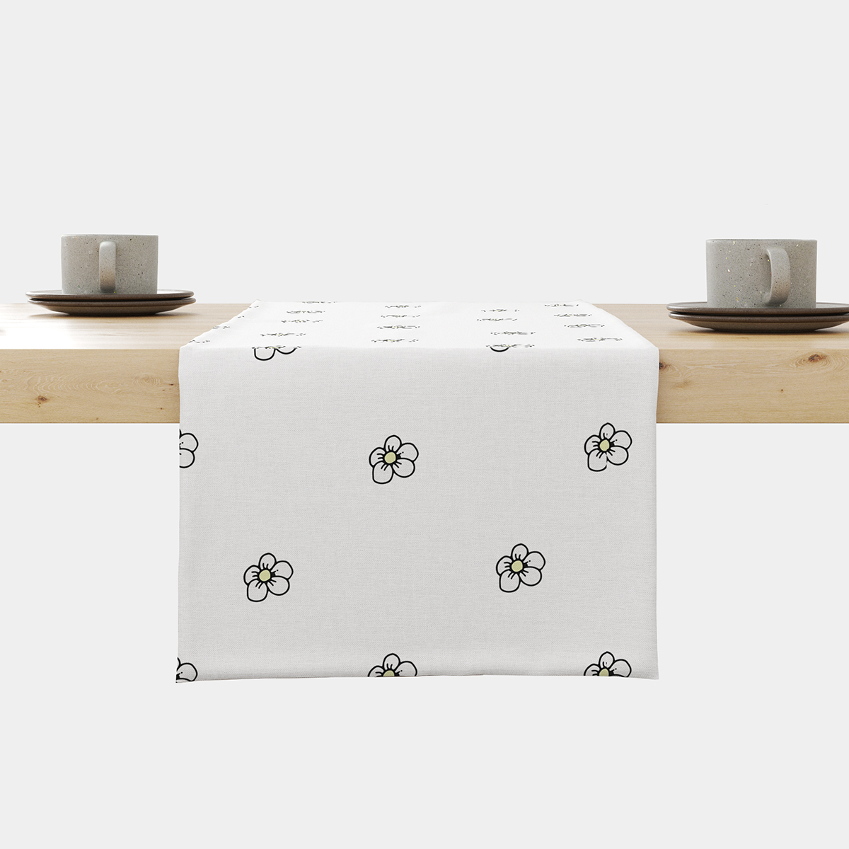 biały bieżnik z rozproszonymi stokrotkami ułożony na stole, widok z przodu