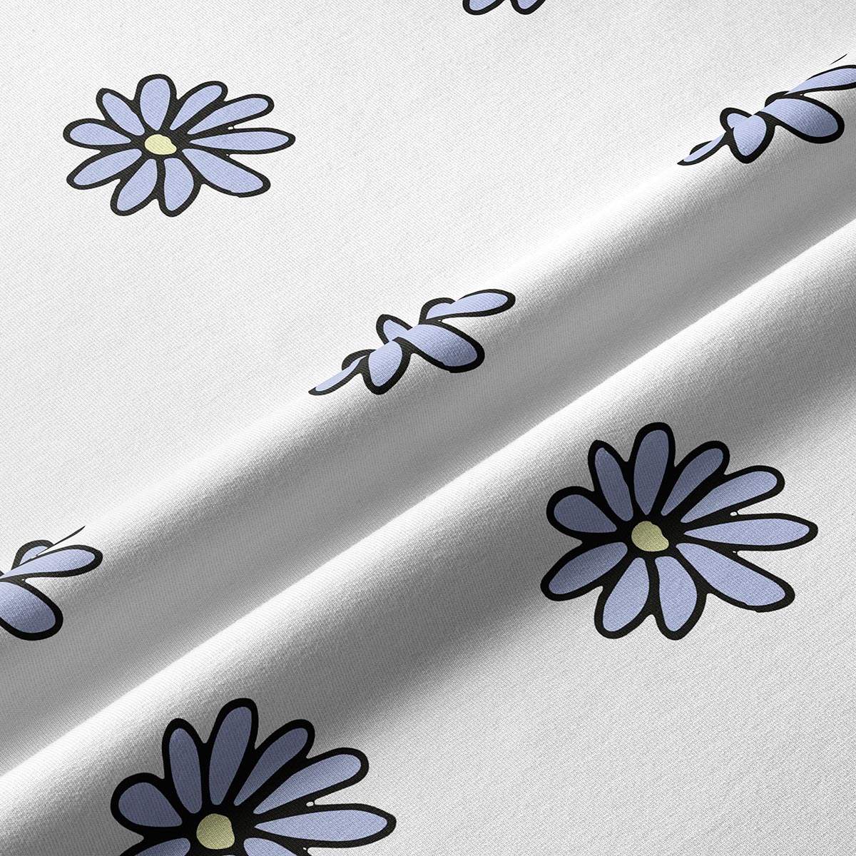 Zbliżenie na tkaninę i nadruk stokrotek ukazujące detale