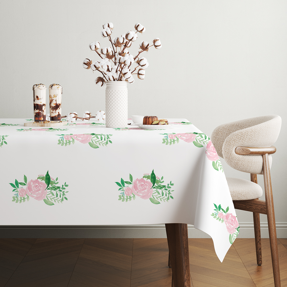 stół udekorowany gałązkami bawełny i subtelnym różanym wzorem na obrusem