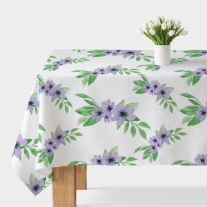 Obrus z akwarelowymi fioletowymi kwiatami rozłożony na stole z wazonem białych tulipanów