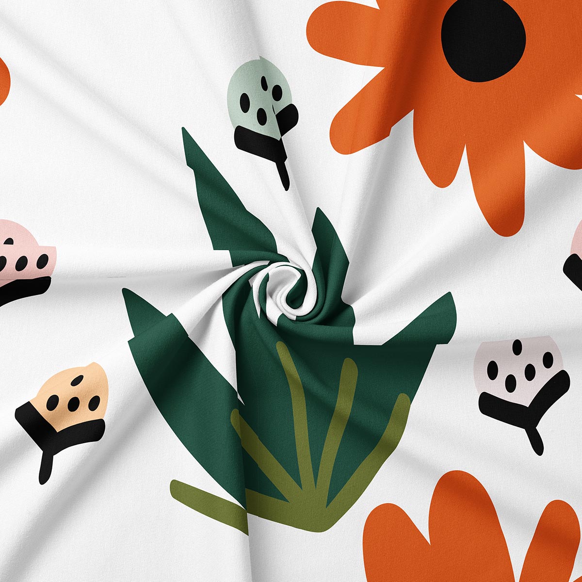 zdjęcie zbliżeniowe tkaniny pokazujące liść i pomarańczowy kwiat oraz fakturę nadruku