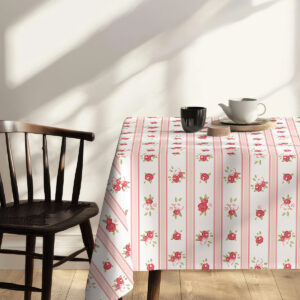 Widok rogu stołu z obrusem ukazujący powtarzalny wzór różyczek i pasów