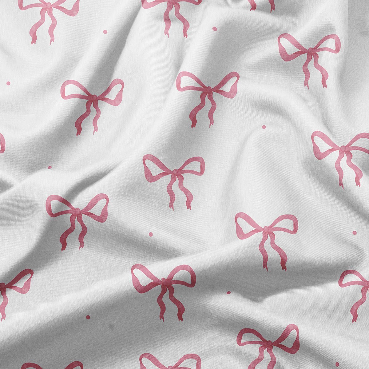 zbliżenie na tkaninę obrusy z różowymi kokardkami ukazujące fakturę i nadruk