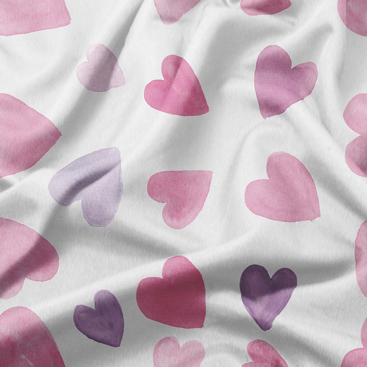 zbliżenie na wzór akwarelowych serc w odcieniach różu i fioletu na tkaninie