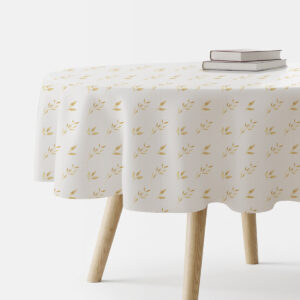 okrągły obrus na stole z delikatnym, powtarzalnym wzorem złotych listków