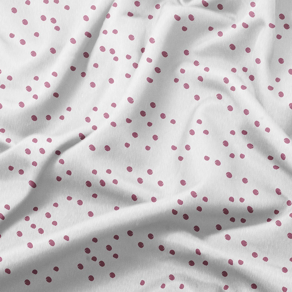 zbliżenie na materiał obrusu pokazujące detal rozproszonych różowych kropek